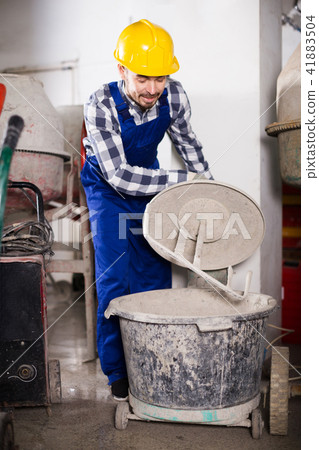 Worker work with cement mixer 41883504