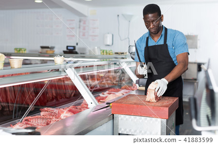 Butcher cutting meat 41883599