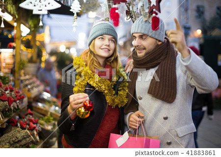 Girl with boy choosing decorations at Christmas market 41883861