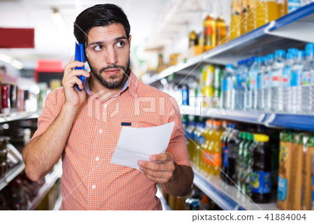 man is choosing mineral water 41884004
