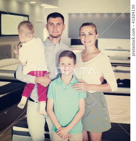 Family posing together in furnishings store Family posing together in furnishings store 41884130