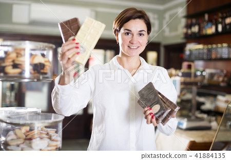 Woman choosing chocolate bar Woman choosing chocolate bar 41884135