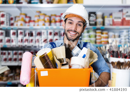 Smiling workman with tools in hands with purchases 41884193