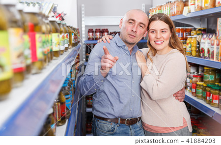 Smiling couple looking pickle goods in the supermarket 41884203