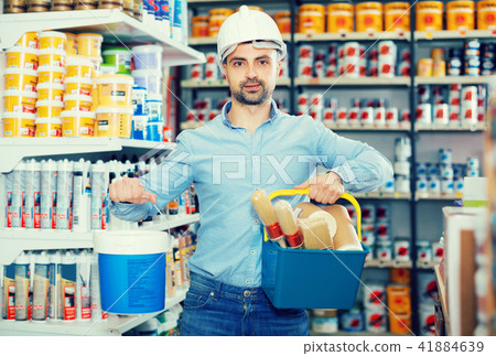 Man in helmet with paint and all instruments for repair 41884639