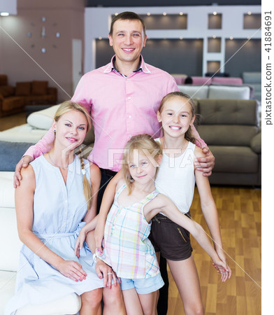 Family posing near new sofa Family posing near new sofa 41884691