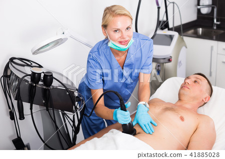 Female doctor is doing vacuum massage procedure for anti-fat to patient Female doctor is doing vacuum massage procedure for anti-fat to patient 41885028