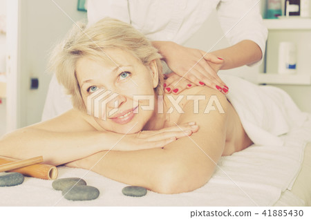 Mature woman having massage Mature woman having massage 41885430