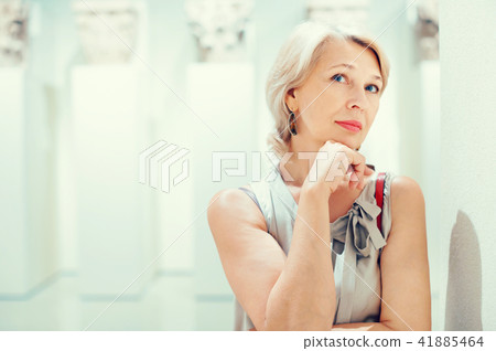 Positive woman in art museum near the antique classical sculpture 41885464