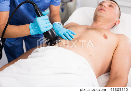 Female specialist is massaging with vacuum to belly of client for anti-fat Female specialist is massaging with vacuum to belly of client for anti-fat 41885530