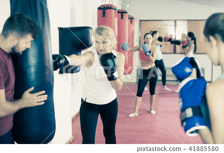 mature woman who is training with punching bag 41885580