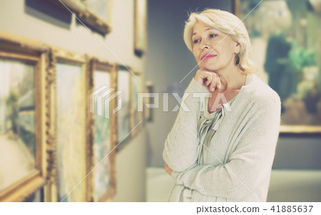 Woman looking at picture collection Woman looking at picture collection 41885637