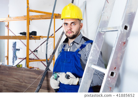 Male worker is ready to work with a dril 41885652