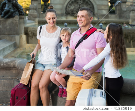 parents with two kids traveling together searching location on paper map parents with two kids traveling together searching location on paper map 41885919