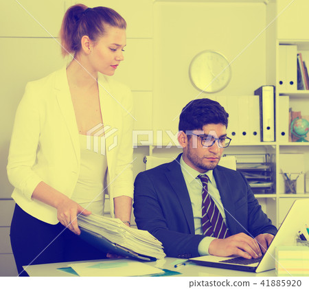 Overworked businessman with sheaf of papers Overworked businessman with sheaf of papers 41885920