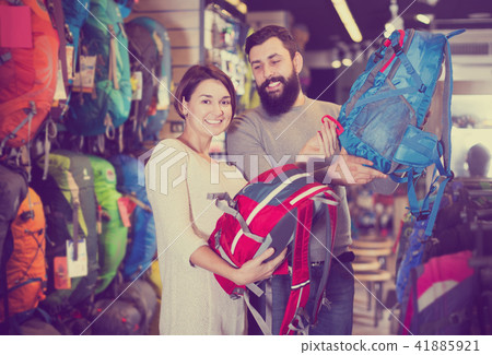Couple choosing rucksack in store 41885921