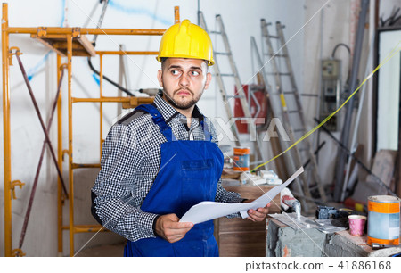 Builder is looking on the project of work Builder is looking on the project of work 41886168
