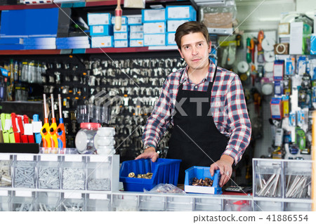 worker in hardware store trading goods for water tap in uniform 41886554