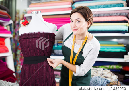 Tailor working at dress 41886950