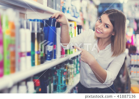 Girl shopping hair care treatments Girl shopping hair care treatments 41887136