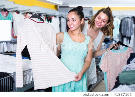 Young female are choosing new clothes Young female are choosing new clothes 41887165