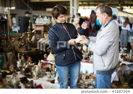 Man and his wife are visiting market of old things 41887264