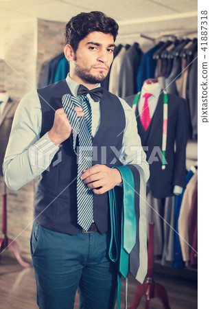 Person is picking up tie for waistcoat Person is picking up tie for waistcoat 41887318
