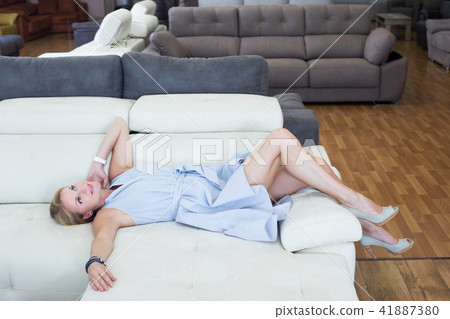 Girl is testing new furniture Girl is testing new furniture 41887380