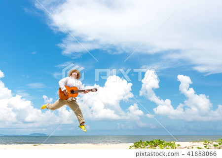 Asian man enjoying summer, playing classic guitar  41888066