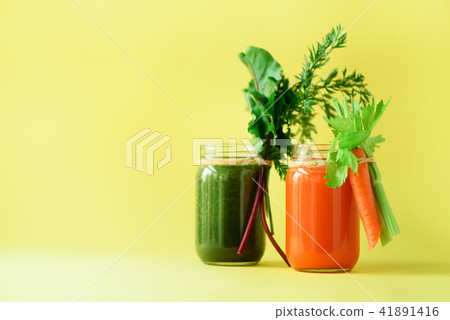 Healthy organic green and orange smoothies on 41891416