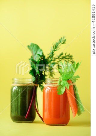 Healthy organic green and orange smoothies on 41891419