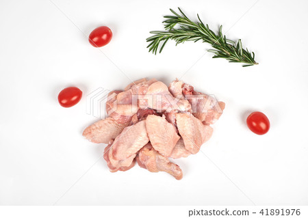 Raw chicken wings, tomatoes and rosemary isolated on white background 41891976