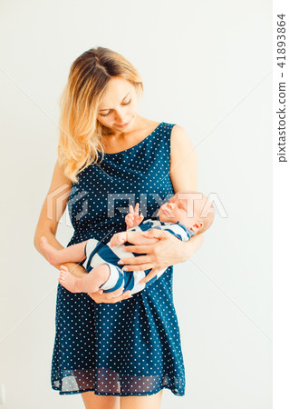 Mother holding her sleeping baby son in the room 41893864