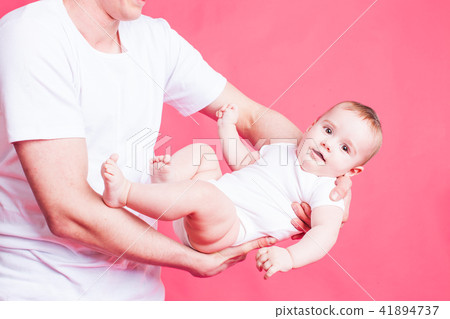 The dad having fun with baby 41894737