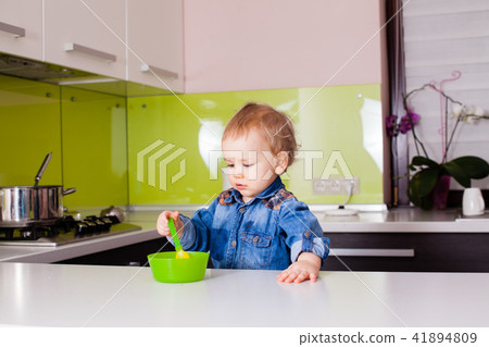 Small baby boy feeding himself 41894809