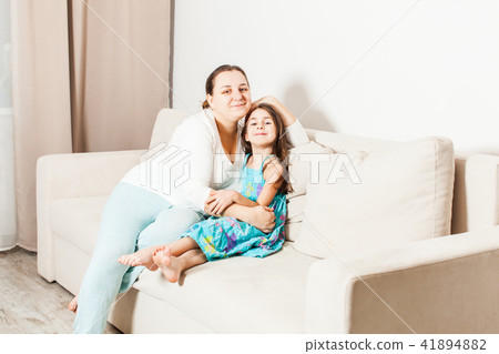 Beautiful mom and daughter in the living room. 41894882