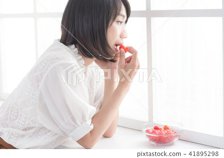 Teenage girl with tomato Teenage girl with tomato 41895298