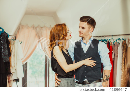 Husband helps to choose dress for his wife Husband helps to choose dress for his wife 41896647