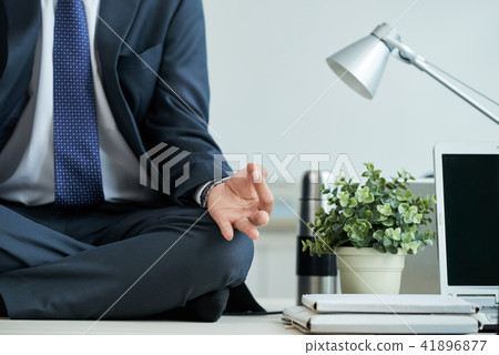 Meditating businessman 41896877