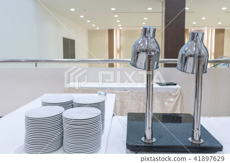 Set of dishes for dinner party at banquet table 41897629