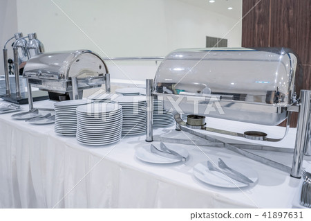 Set of dishes for dinner party at banquet table 41897631