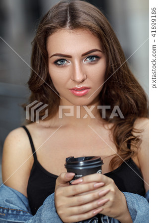 woman with coffee on the street woman with coffee on the street 41899186