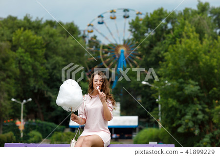 attractive woman holding sweet cotton candy attractive woman holding sweet cotton candy 41899229