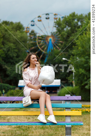 attractive woman holding sweet cotton candy attractive woman holding sweet cotton candy 41899234