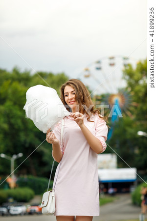 attractive woman holding sweet cotton candy attractive woman holding sweet cotton candy 41899236