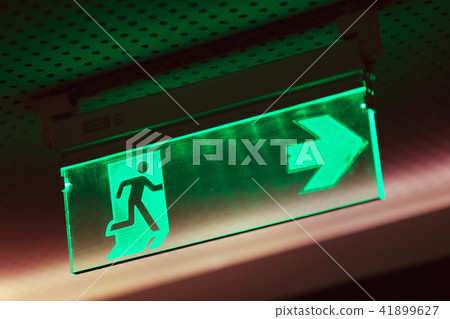 Illuminated green emergency exit sign Illuminated green emergency exit sign 41899627