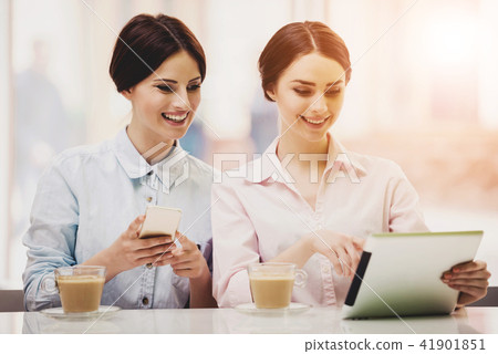 Two Women in Cafeteria with Coffe and Tablet. 41901851