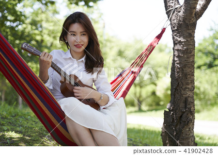 Young woman, guitar, hammock, park Young woman, guitar, hammock, park 41902428