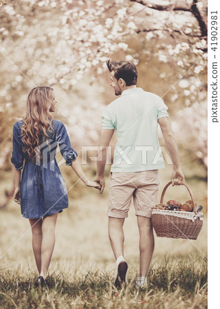 Young Couple Walking in Summer Park on Sunny Day. Young Couple Walking in Summer Park on Sunny Day. 41902981