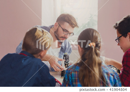 Stem education. Kids creating robots with teacher 41904804